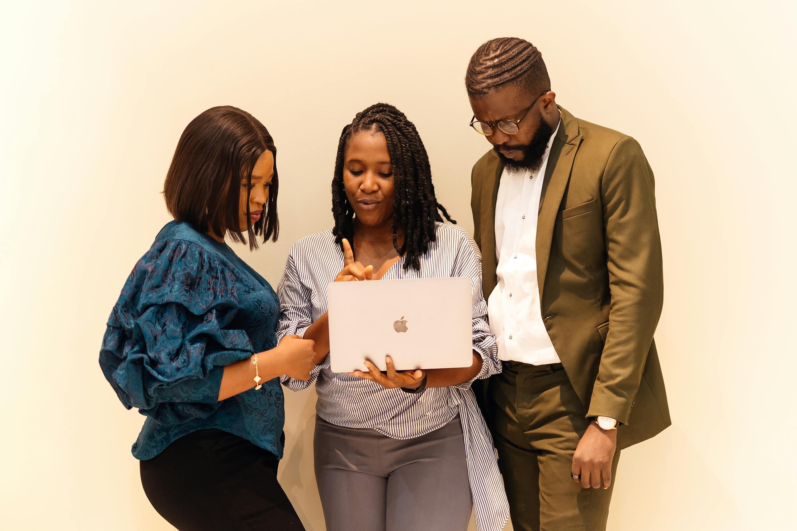 Business professionals collaborating with a laptop during a meeting in Lagos, Nigeria.